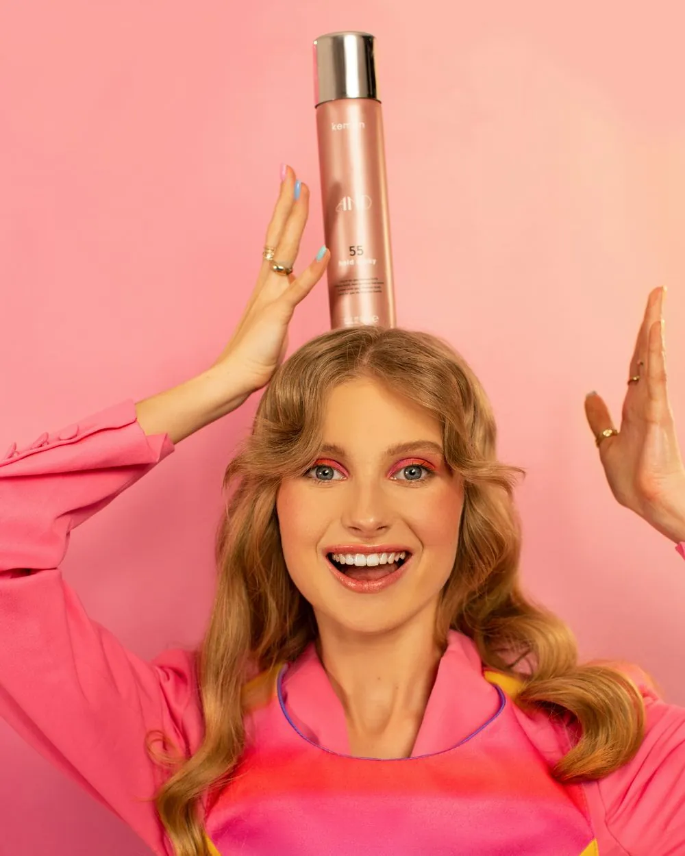 Creator posing with a hair spray product