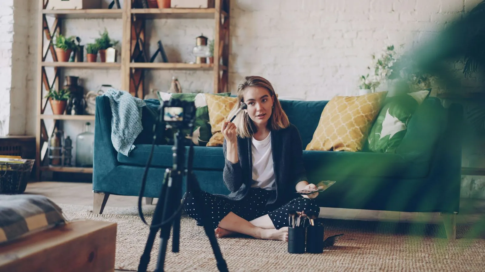 Beauty creator filming a make-up tutorial at home