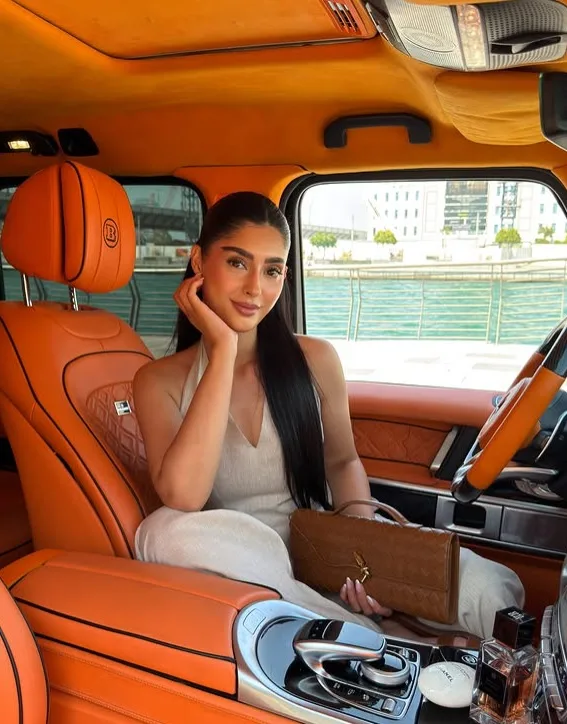 Lifestyle creator in a luxury car by the Dubai waterfront