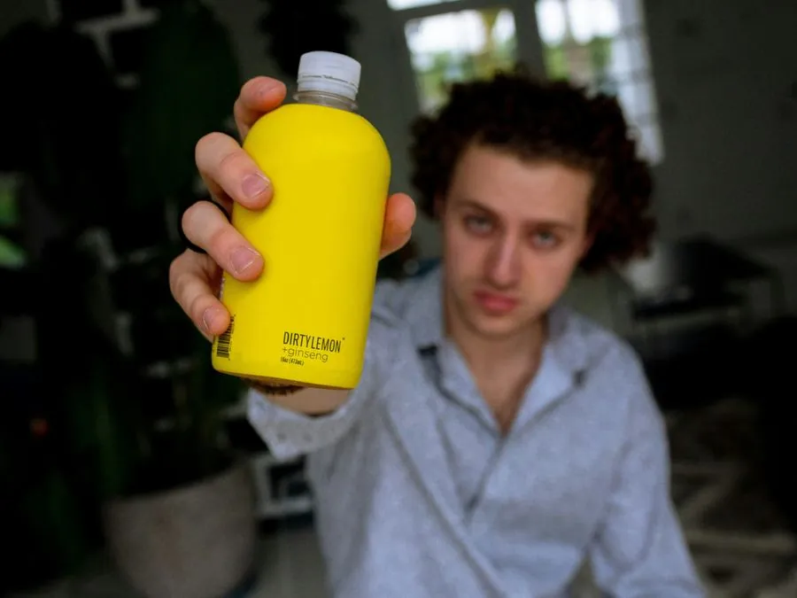 Creator holding a branded drink bottle