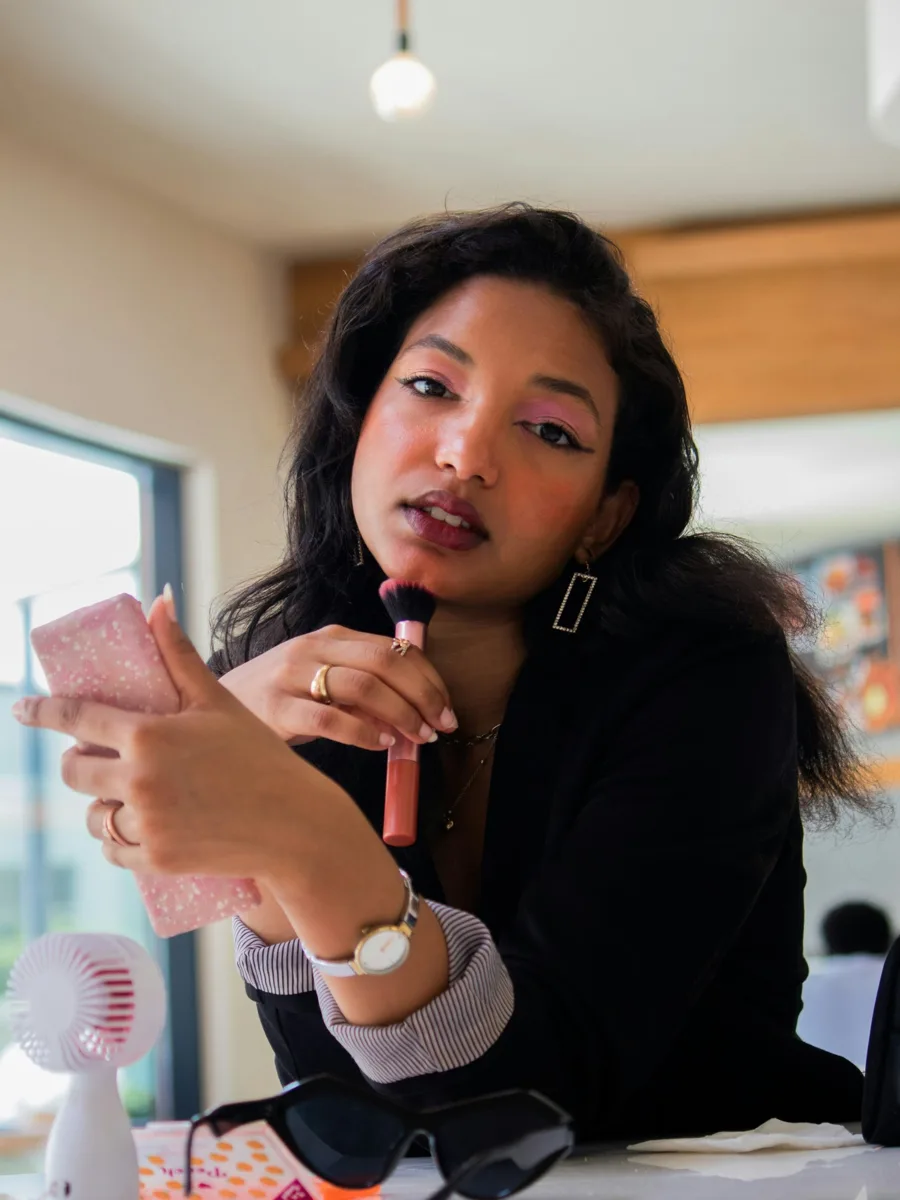 Beauty creator applying blush with a brush