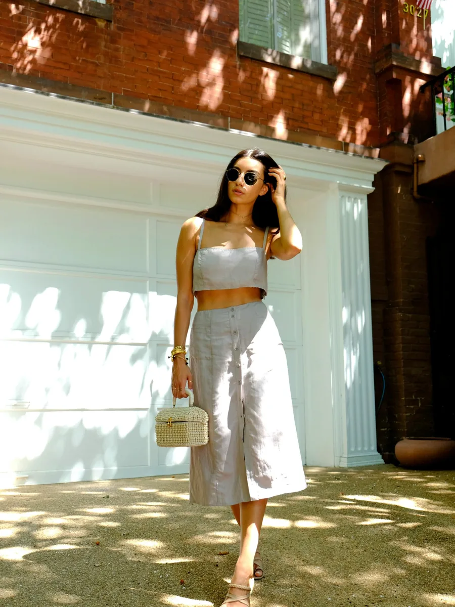 Fashion creator in a linen two-piece on a sunny street